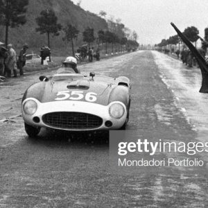 Judges stopping the car of Italian racing car driver Luigi Musso running the Mille Miglia Automobile Race. Italy, April 1956. (Photo by Emilio Ronchini/Mondadori via Getty Images)