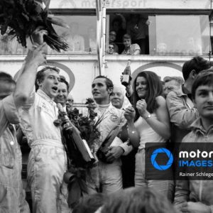 CIRCUIT DE LA SARTHE, FRANCE - JUNE 15: Jacky Ickx and Jackie Oliver celebrate their victory on the podium during the 24 Hours of Le Mans at Circuit de la Sarthe on June 15, 1969 in Circuit de la Sarthe, France. (Photo by Rainer Schlegelmilch)