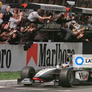 Mika Hakkinen punches the air as he drives past the McLaren team on the pitlane wall after winning the Spanish Grand Prix ... Pic Steve Etherington.