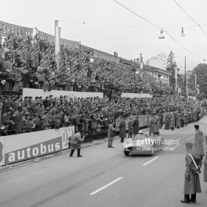 The spectators applauding the racing car of Italian racing car driver Luigi Musso passing by during the Mille Miglia Automobile Race. Brescia, April 1956. (Photo by Emilio Ronchini/Mondadori via Getty Images)