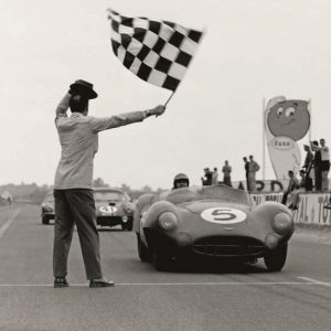 CIRCUIT DE LA SARTHE, FRANCE - JUNE 21: Carroll Shelby / Roy Salvadori, David Brown Racing, Aston Martin DBR1/300 and Peter Lumsden / Peter Riley, William S. Frost, Lotus Elite Mk 14-Coventry Climax FWE, take the chequered flag at the end of the race during the 24 Hours of Le Mans at Circuit de la Sarthe on June 21, 1959 in Circuit de la Sarthe, France. (Photo by LAT Images)