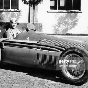 Fangio in Alfa Romeo, prior to the San Remo Grand Prix, Italy, 1950. Juan Manuel Fangio won the race, his first at the wheel of an Alfa Romeo. In his Formula 1 career between 1950 and 1958, Fangio won a then record 24 Grands Prix, driving for Alfa Romeo, Maserati and Ferrari and won the World Drivers' Championship in 1951, 1954, 1955, 1956 and 1957, a record which remains unequalled. The most remarkable aspect of Fangio's record is that these successes came from a career which only lasted for 51 races. (Photo by National Motor Museum/Heritage Images/Getty Images)