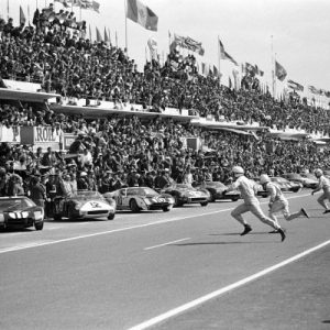CIRCUIT DE LA SARTHE, FRANCE - JUNE 22: Drivers sprint for their cars at the start. Nearest to camera John Surtees runs to his Ferrari 3330P (no.19) on pole position and Richie Ginther runs to his Ford GT40 Mk.1 (no.11) during the 24 Hours of Le Mans at Circuit de la Sarthe on June 22, 1964 in Circuit de la Sarthe, France. (Photo by Rainer Schlegelmilch)