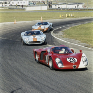 DAYTONA INTERNATIONAL SPEEDWAY, UNITED STATES OF AMERICA - FEBRUARY 04: Udo Schütz / Nino Vaccarella, Autodelta S.p.a.,	Alfa Romeo T33/2, leads Paul Hawkins / David Hobbs, J. W. Automotive Eng., Ford GT40, and Jacky Ickx / Brian Redman, J. W. Automotive Eng., Ford GT40 during the Daytona 24 Hours at Daytona International Speedway on February 04, 1968 in Daytona International Speedway, United States of America. (Photo by LAT Images)