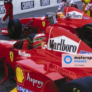 AUTODROMO NAZIONALE MONZA, ITALY - SEPTEMBER 07: Eddie Irvine, Ferrari F310B, and Michael Schumacher, Ferrari F310B, in the pitlane during the Italian GP at Autodromo Nazionale Monza on September 07, 1997 in Autodromo Nazionale Monza, Italy. (Photo by LAT Images)