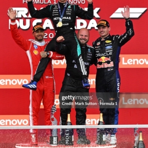 MONTREAL, QUEBEC - MAY 24: Race winner Andrea Kimi Antonelli of Italy and Mercedes AMG Petronas F1 Team Second placed Lewis Hamilton of Great Britain and Scuderia Ferrari Third placed Max Verstappen of the Netherlands and Oracle Red Bull Racing and Dean Hale, Senior Race Team Composite Technician at Mercedes AMG Petronas F1 Team celebrate on the podium during the F1 Grand Prix of Canada at Circuit Gilles-Villeneuve on May 24, 2026 in Montreal, Quebec. (Photo by Mark Sutton - Formula 1/Formula 1 via Getty Images)